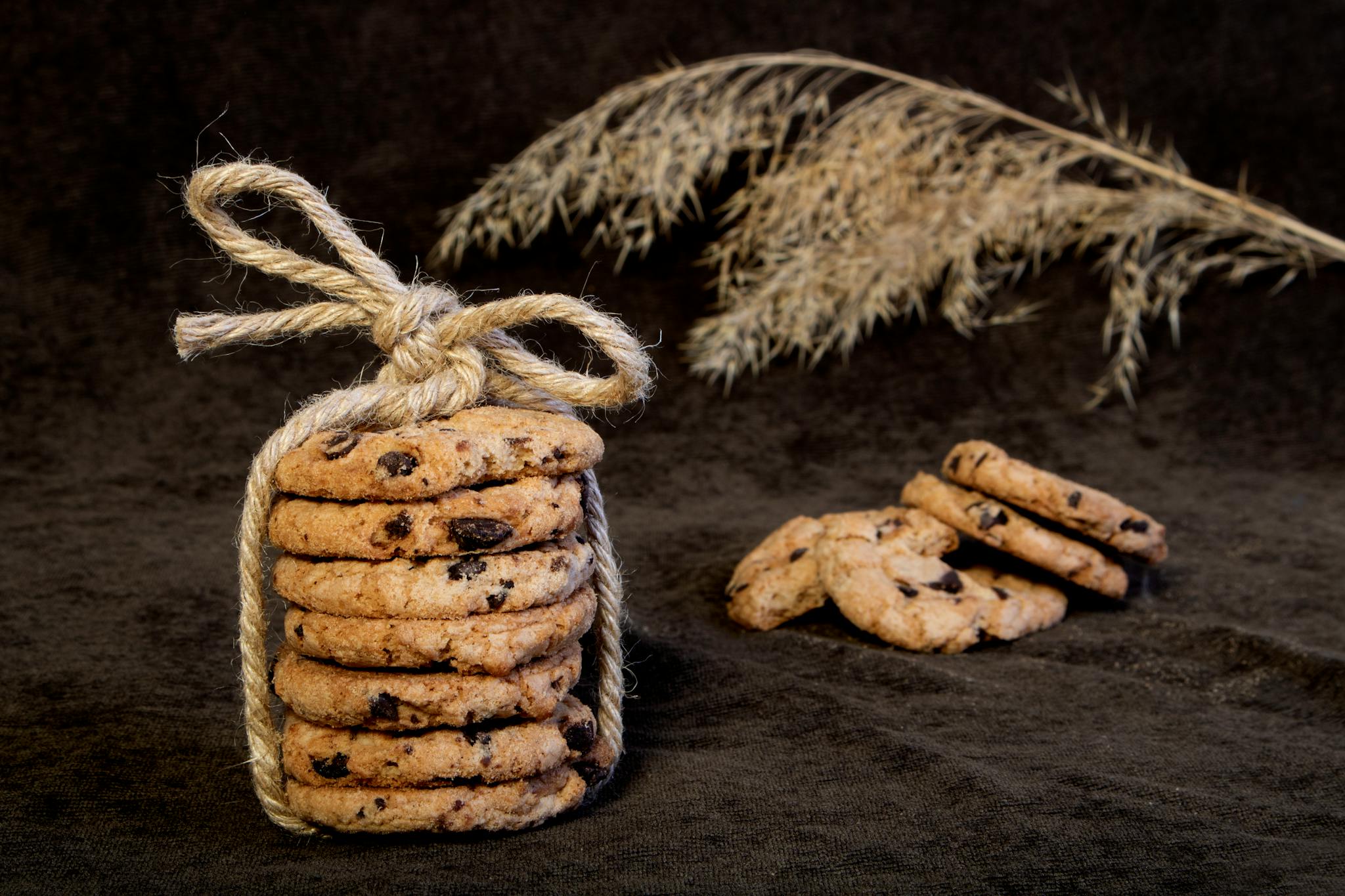 Delicious chocolate chip cookies stacked and tied with twine, exuding a rustic charm.