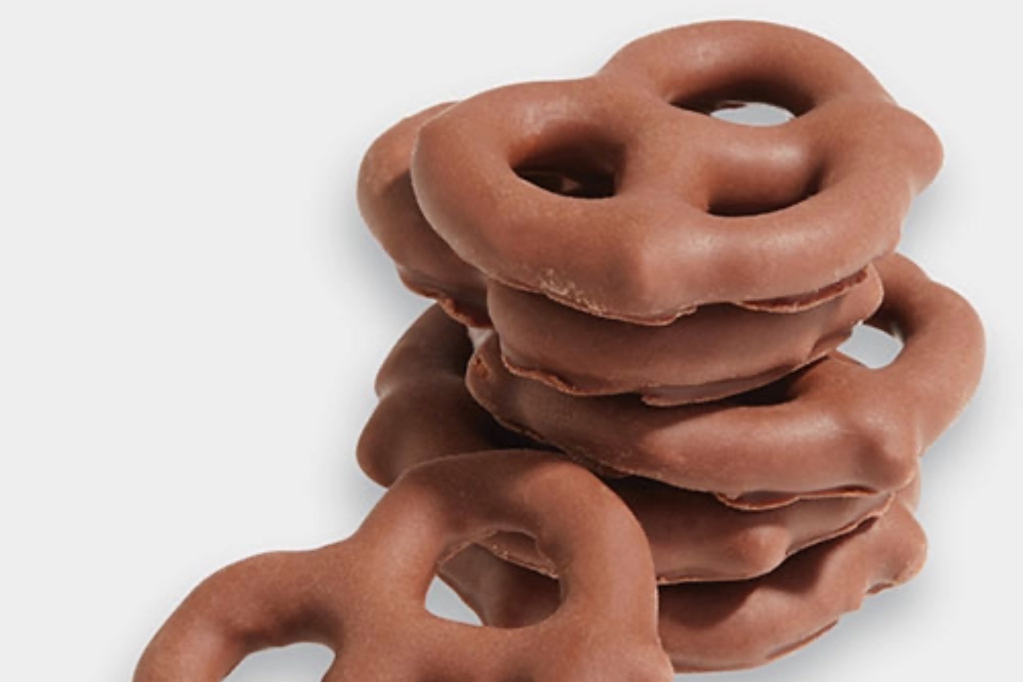 Several chocolate-coated pretzel twists arranged neatly, showing the glossy chocolate finish and visible pretzel shape.